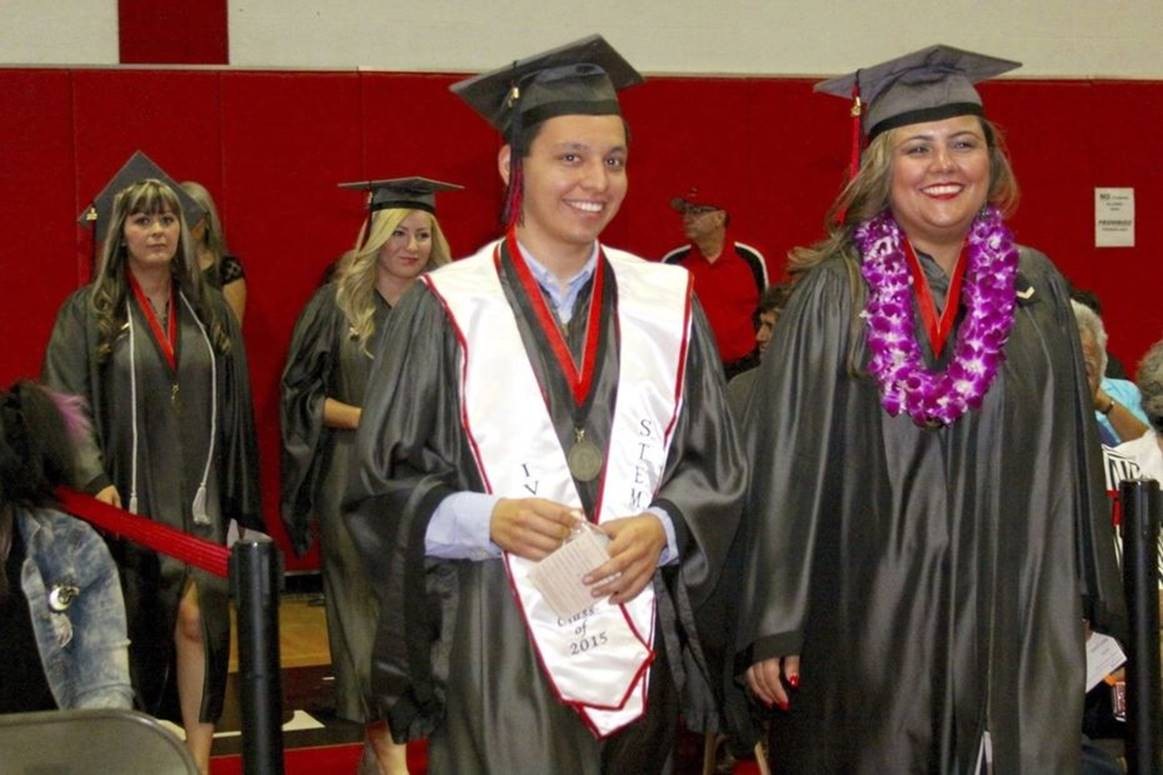 FROM LEFT: Biology major Mario Lopez and administration of justice major Rocio Lopez march toward their seats Saturday during the Class of 2015 commencement exercises at Imperial Valley College. JOSELITO VILLERO PHOTO